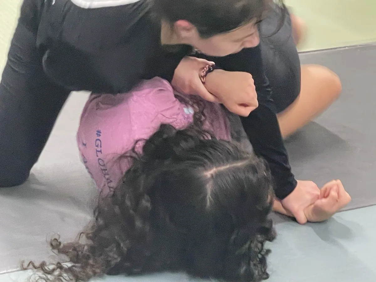 Two women drilling ground defense during women's Krav Maga training at SD4ALL, Cedar Knolls NJ